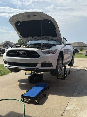 Servicing a customer's Mustang in their driveway. Oil change and tire rotation.