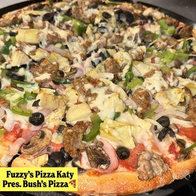 Bush's Pizza; features Artichoke Hearts, Pepperoni, Canadian Bacon, Italian Sausage, Green Peppers, Onions, Mushrooms and Black Olives