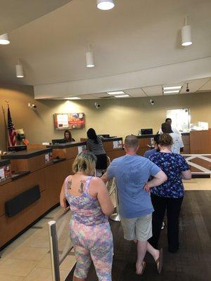 The line extends behind me, and there is only two tellers