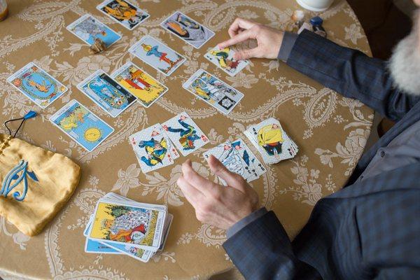 Reading for a client with a traditional Tarot deck and a super-hero playing card set.