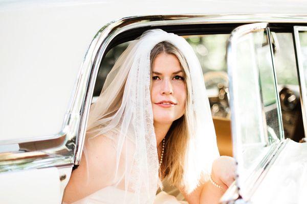 Bride in a vintage car before ceremony