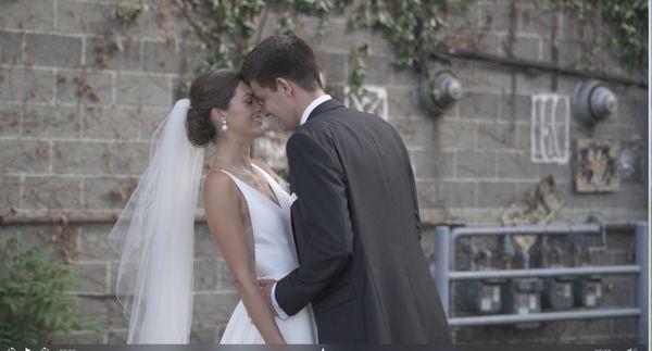 Groom embraces and kisses his new bride