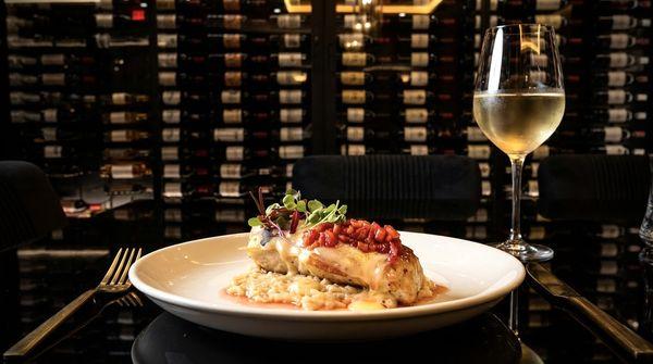 Sea Bass Seduction- sea bass resting in creamy risotto, finished with a white chocolate beurre blanc & macerated strawberries