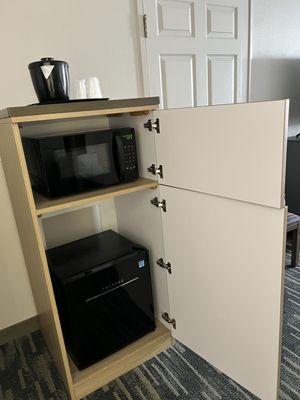 Microwave and min refrigerator in cabinet
