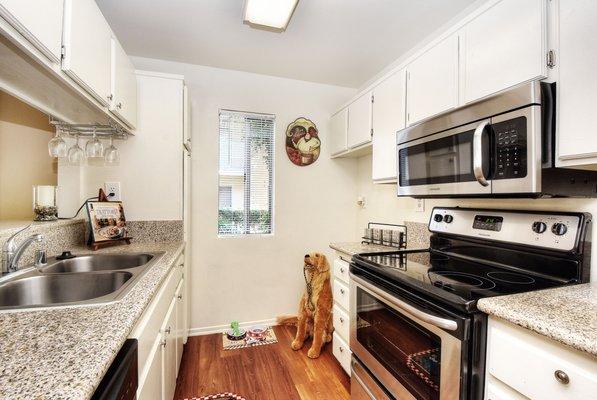 Upgraded galley style kitchen with   stainless ranges and microwaves.
