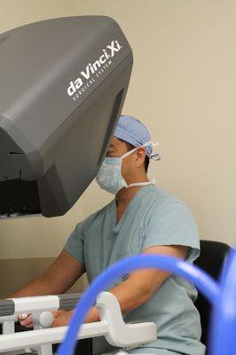Dr. Shawn Tsuda at the surgical robot performing a bariatric procedure