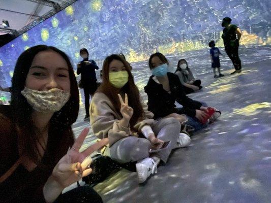 Quest students pose in front of a Van Gogh painting at our Art Exhibit Field Trip!