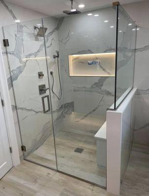 Frameless shower enclosure