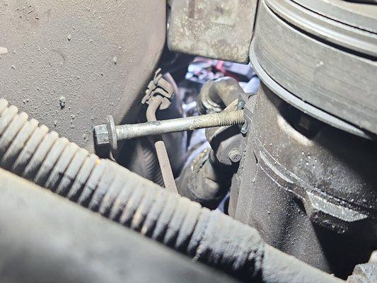 A/C Compressor Bolt  that was never screwed back down. belt is to lose  to turn. never again