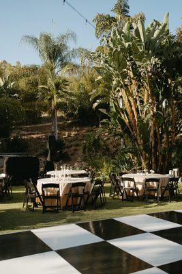 Black Resin Folding Chair with Pad + 60" Round Table + Poly 120" Round in Champagne + Black and White Checkered Dance Floor