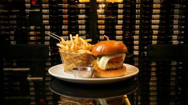 The Gibson Royale Burger- Challah bun, whole grain mustard spread, 8 oz dry-aged burger, cheddar, carmelized onion, tomato and iceberg lettu