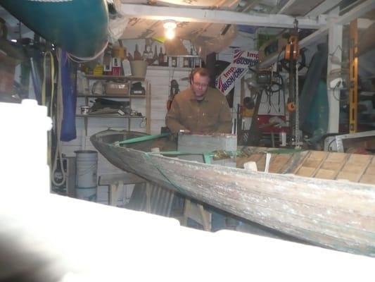 Chris Carr of Saugatuck Wooden Boat scrapping paint
