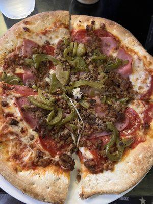 Meat lovers personal pie with green peppers