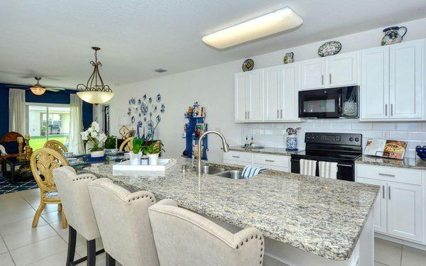 Timeless white kitchen with white subway tiles and granite countertops