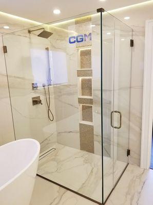 Frameless shower enclosure