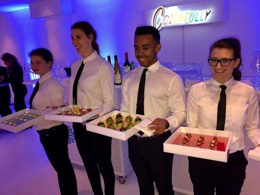 Tapuz Staffing Servers with passed hors d'oeuvre trays at a New York City event