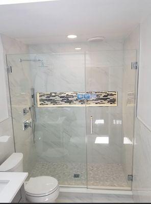 Frameless shower enclosure