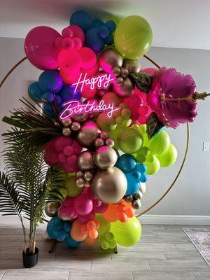7.2 Ft Hoop frame with tropical themed balloons and hot pink happy birthday neon sign.