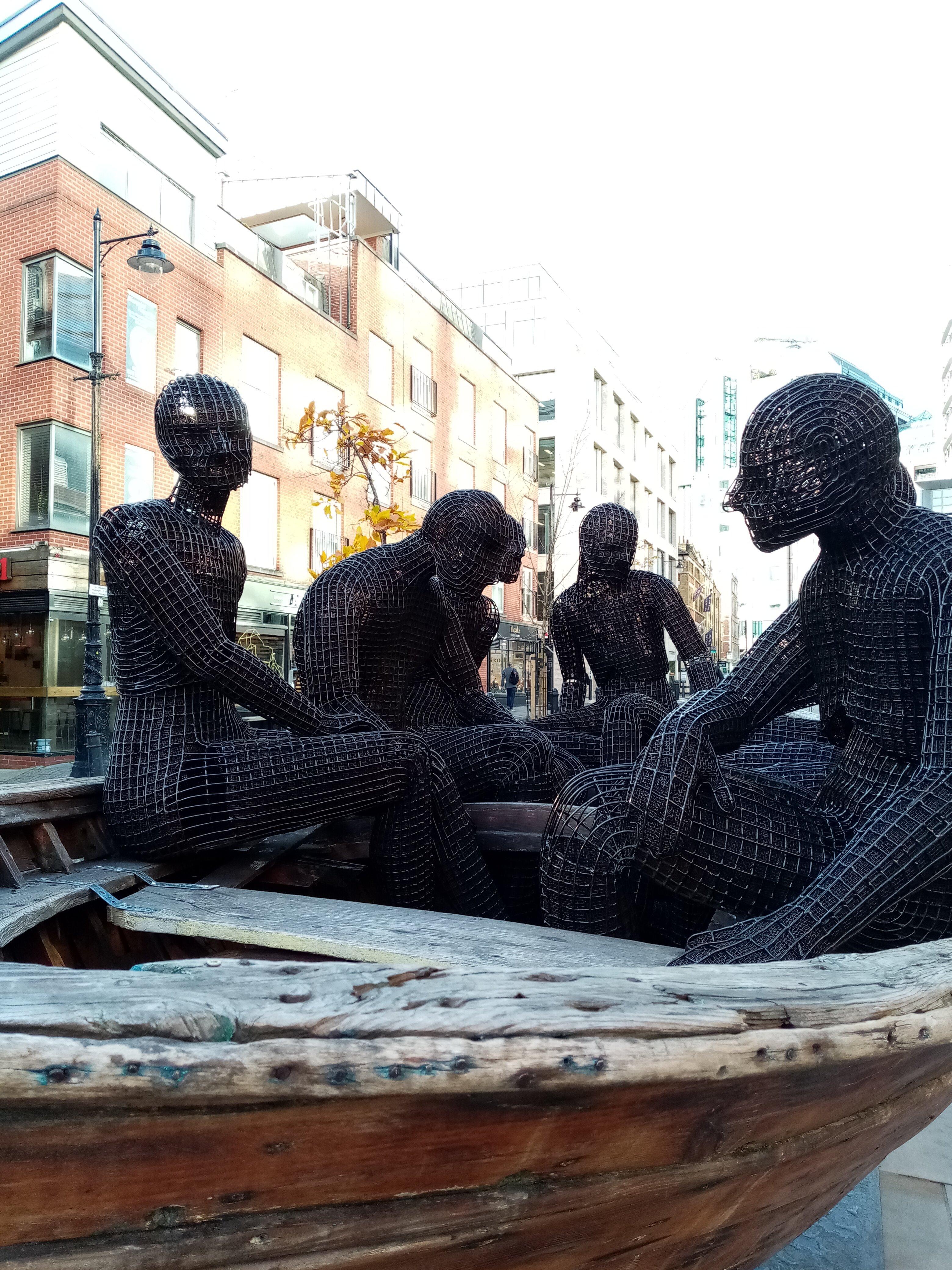Wooden Boat with Seven People Sculpture