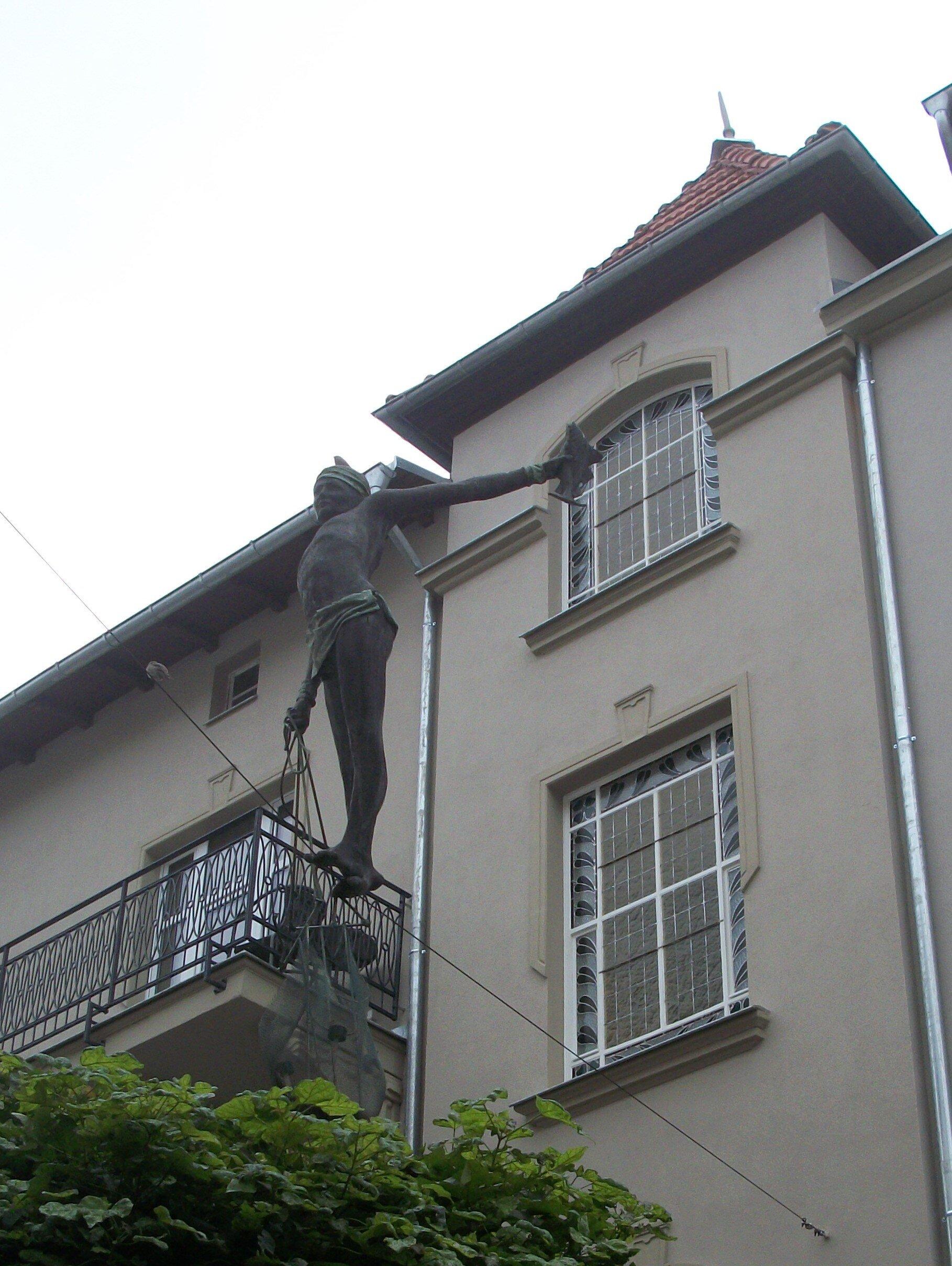 Statue Of A Tightrope Fisherman