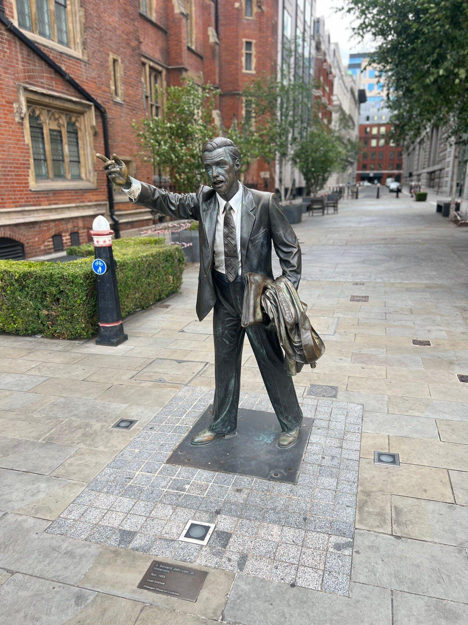 Statue Of City Worker Hailing Cab