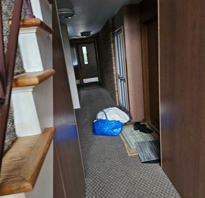 Neighbors door below. They slam doors constantly nonstop, trash the hallways, and leave their dirty laundry in lobby for hours as shown