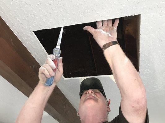 Cutting hole in ceiling for air discharge