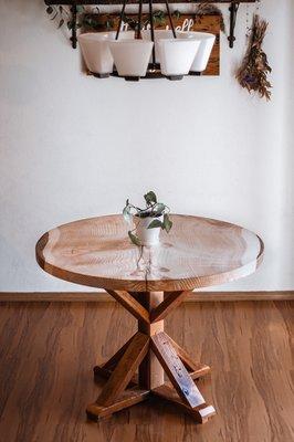 Live edge round dining table with a reclaimed base.