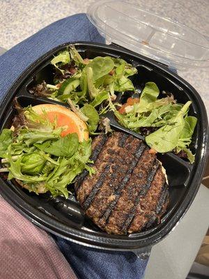 Hamburger with salad. On my lap because I rushed to the gate only then to be delayed. 
