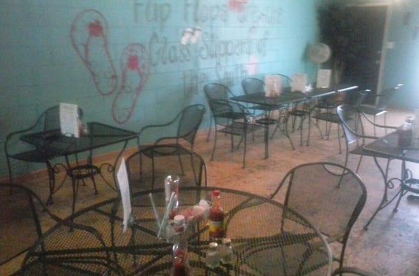 Main dining area and "Flip flps are the glass slippers of the South" mural