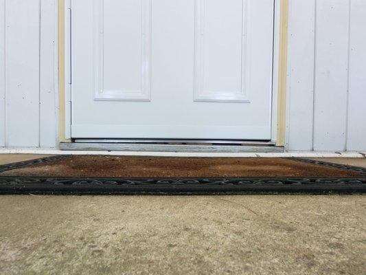 Cardboard under threshold? Why? They had nothing else to level it out...I was told