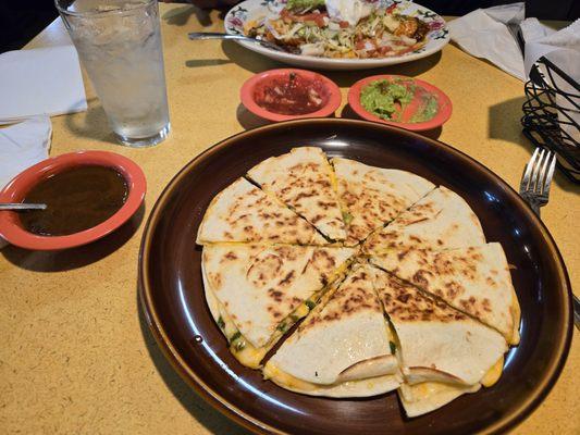 Cheese and jalapeño quesadilla. Side poblano mole and in the top a massive burrito.
