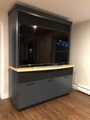 Bamboo tv cabinet with a dark stain and clear countertop.