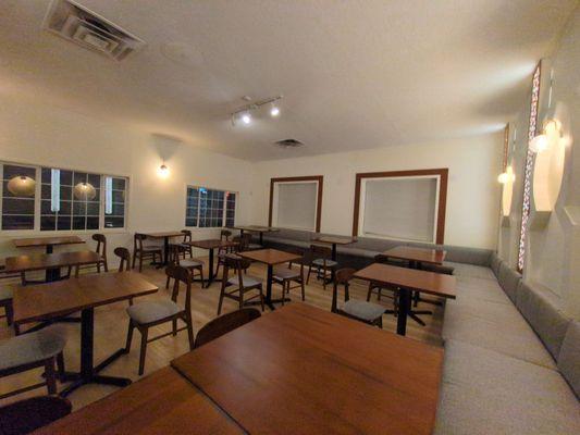 Back dining room is roomy some tall tables along the edge and short in the middle