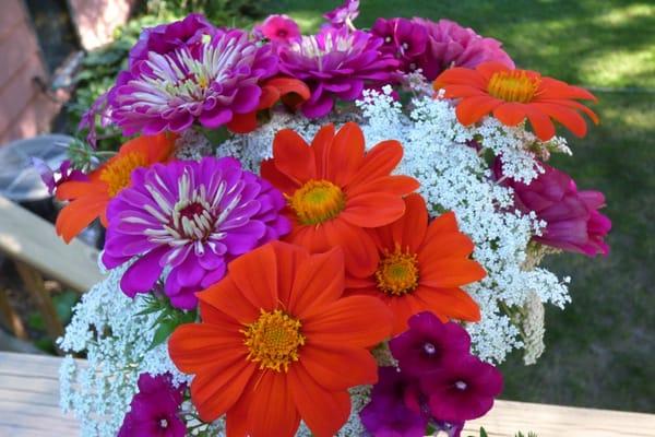 Table centerpiece of Minnesota-grown garden flowers  by Renee Arcand for an August 1 wedding