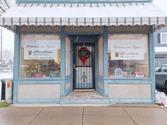 Front of shop with updated awning and signs.