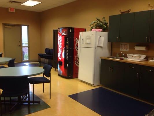 Kitchen with vending machine, fridge, coffee and a back door for cigarette smoking