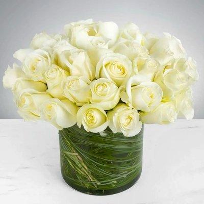 Simply white roses to express purity, innocence and reverence.