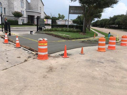 Apartment complex cones to keep trespassers off drying new cement.