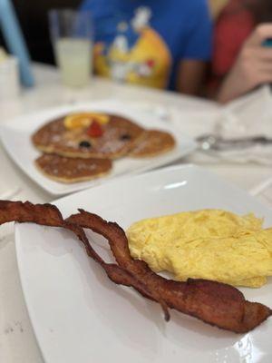 Kid' Mickey pancakes with a side of bacon and eggs