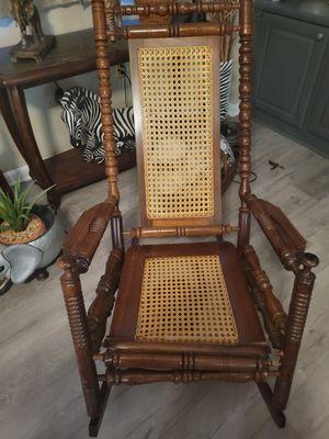 Vintage rocking chair with two broken spindle ends. Broken seat at.the edge. Wicker seat in tact. Kim Knox 937-602-4493