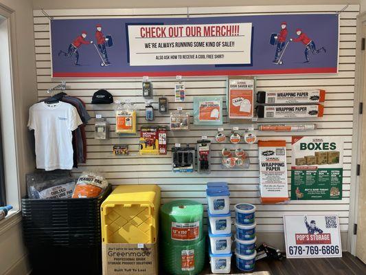 The merch wall inside the office, plenty of moving day goodies to choose from!