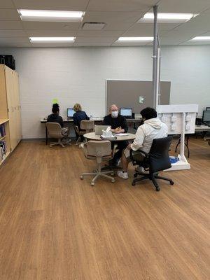 Teachers working one on one with students.