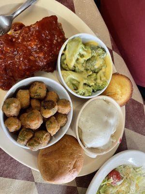 meatloaf with, fried okra, broccoli with cheese, mashed potatoes with white gravy and a side of salad plus cornbread, and a bread bun.