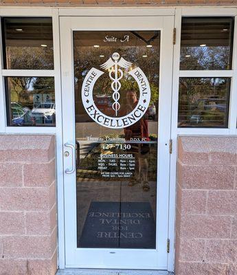 This is the door to the place, along with their hours of operation. Photo taken November 17, 2022.