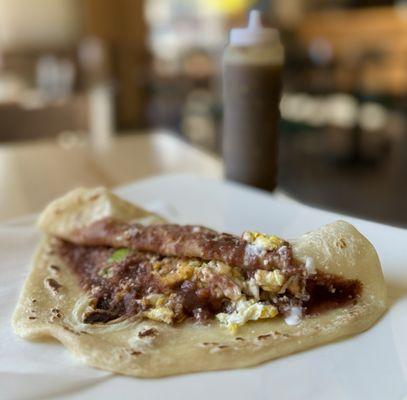 Baleada Especial w/ fried beans, cheese, scrambled egg, avocado, sour cream | $6.99 (housemade habanero + jalapeno hot sauce)