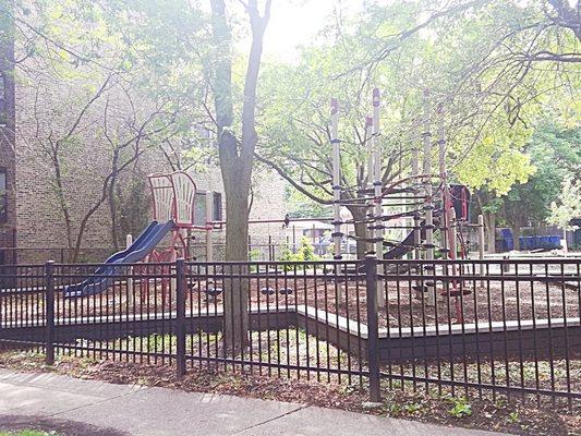 Jungle gym play area. Water fountain and sand dig, swings.