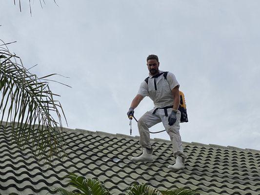 Michael with his sprayer treating on the roof