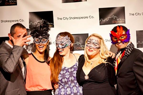 Audience members enjoy a red carpet masquerade ball.