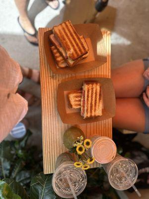 Two toasties (top), one cappuccino (middle), and two charcoal lattes (bottom)